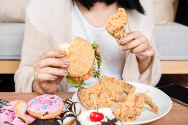 unhealthy woman over eating fast food burgers, fired chicken, do