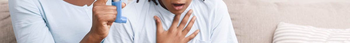 Afro mother holding asthma inhaler for daughter