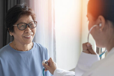 Happy elderly patient with medical health checkup with cardiolog