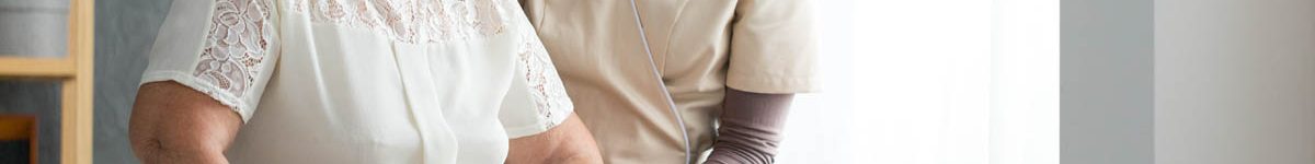 Nurse helping senior to walk