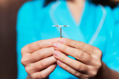 female contraceptive spiral in the hands of a nurse. device forb