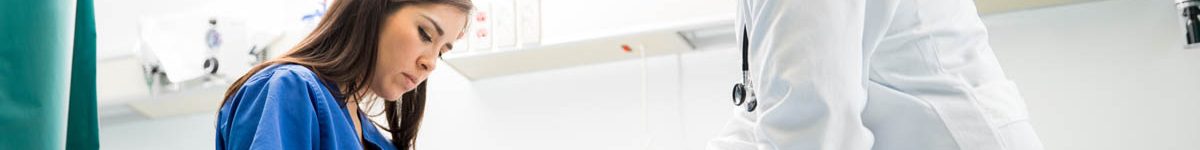 Doctors bandaging the arm of a patient