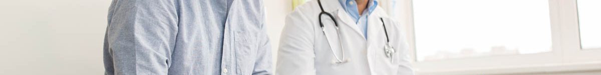 smiling doctor and young man meeting at hospital