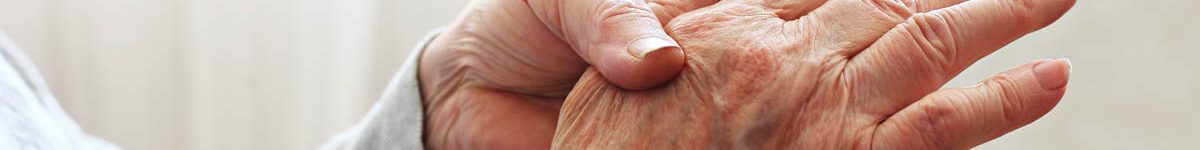 Elderly woman applying moisturizing lotion cream on hand palm, easing aches. Senior old lady experiencing severe arthritis rheumatics pains, massaging, warming up arm. Close up, copy space, background
