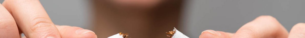 Addiction. Closeup of young attractive woman breaking cigarettes