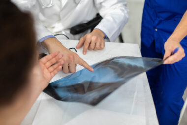 The doctors explain to the patient the reason she is experiencing pain in her lungs.