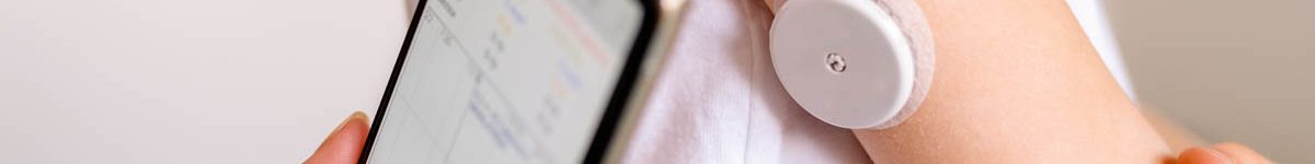 CGM -system of continuous monitoring of glucose on child’s arm.