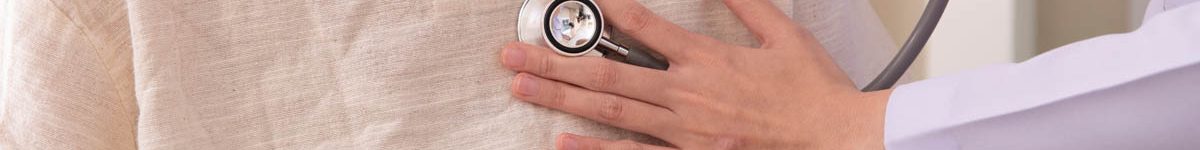 doctor listening to elderly patient’s heart