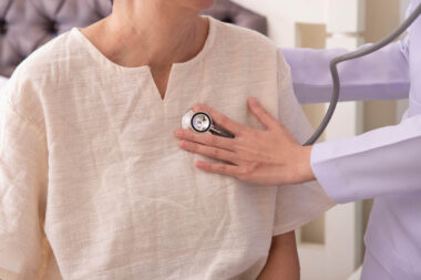 doctor listening to elderly patient’s heart